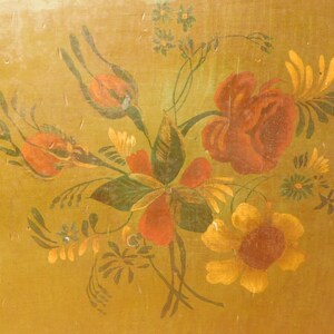 May include: A painted floral design featuring red roses, orange buds, and yellow sunflowers on a gold background. The artwork includes green leaves and stems, creating a vintage, botanical theme.