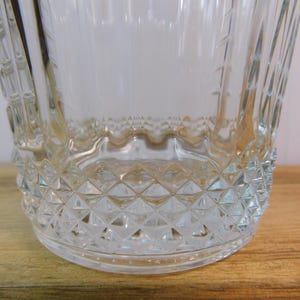 Pode incluir: Balde de gelo de vidro transparente com um padr&atilde;o de diamante na base e uma al&ccedil;a texturizada. O balde tem uma borda ondulada e linhas verticais nas laterais. O vidro &eacute; transparente.