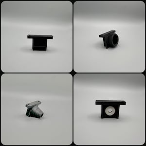 May include: Four black 3D-printed plastic components are shown against a white backdrop. The parts have different shapes, including a T-shape, a cylindrical form, and a shape with a circular aperture. The parts appear to be components of a larger assembly.
