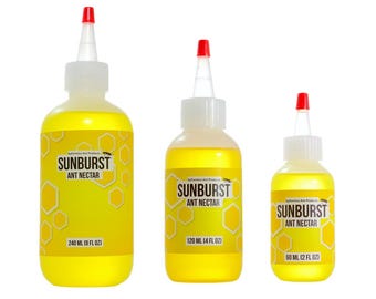 May include: Three bottles of Sunburst Ant Nectar with yellow liquid and white and red caps. The bottles are labeled with the product name and volume: 240 ml (8 fl oz), 120 ml (4 fl oz), and 60 ml (2 fl oz).