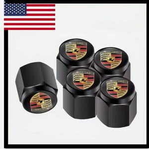 May include: Black tire valve stem caps with the Porsche logo. The caps have a black hexagonal design with a circular emblem featuring a horse and shield in red, gold, and black.