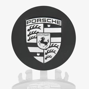 May include: A set of three ceramic mugs with a speckled, matte finish. The mugs are in shades of cream, light gray, and dark gray. Each mug has a simple, minimalist design, perfect for coffee or tea.