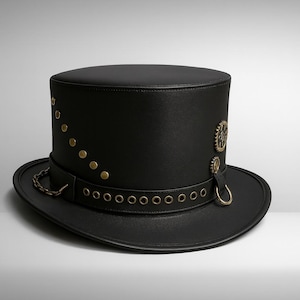 May include: A black top hat with a wide brim. The hat features brass-colored rivets, a decorative chain, and gear-shaped embellishments. The hat has a steampunk aesthetic.