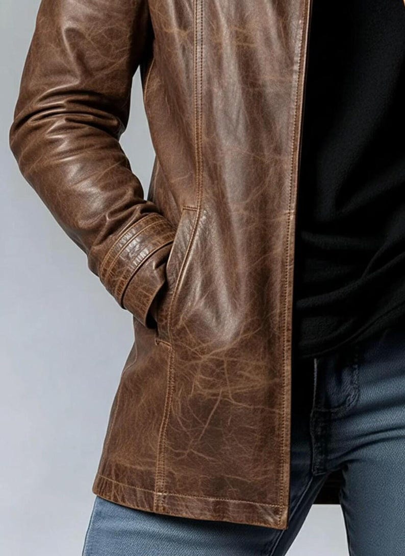 May include: A brown leather jacket with a classic design. The jacket features a notched collar, a button-down front, and multiple pockets. The leather has a distressed look, adding to its vintage appeal.