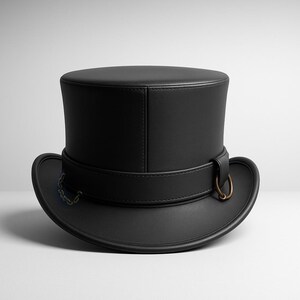 May include: A black top hat with a rounded crown and a wide brim. The hat features a leather band with a metal ring and a small chain detail. The hat is made of a smooth, matte material.