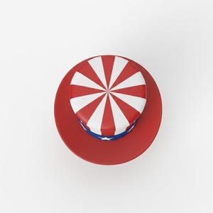 May include: A red, white, and blue top hat with a circular brim. The top of the hat features red and white stripes radiating from the center. A blue band with white stars encircles the base of the hat.