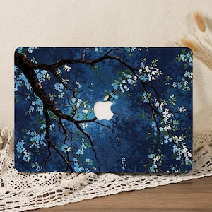 Puede incluir: Una funda rígida rectangular para portátil con un fondo azul marino oscuro y una ilustración detallada de ramas de árbol cubiertas de pequeñas flores de color azul claro y blanco, con un recorte central para el logotipo plateado de Apple.
