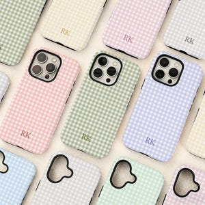 May include: A selection of phone cases in pastel shades such as pink, green, and blue. Each case has a gingham design and the initials "RK". The cases are designed for a smartphone.