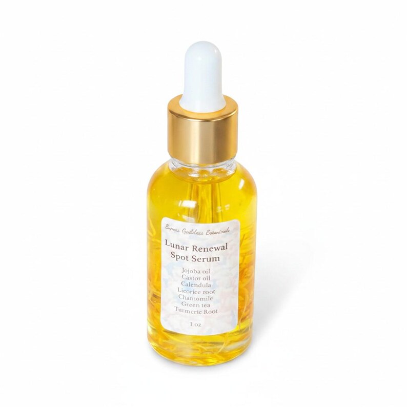 May include: A clear glass bottle of Lunar Renewal Spot Serum with a gold cap and white dropper. The bottle contains a yellow liquid and has a white label with the product name and ingredients: Jojoba oil, Castor oil, Calendula, Licorice root, Chamomile, Green tea, and Turmeric root. The bottle is 1 oz.