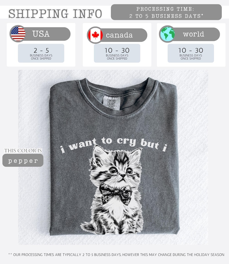 May include: Pepper-colored t-shirt featuring a detailed illustration of a kitten wearing a bow tie, with the text "i want to cry but i" above the image. The shirt is folded and displayed on a white surface.