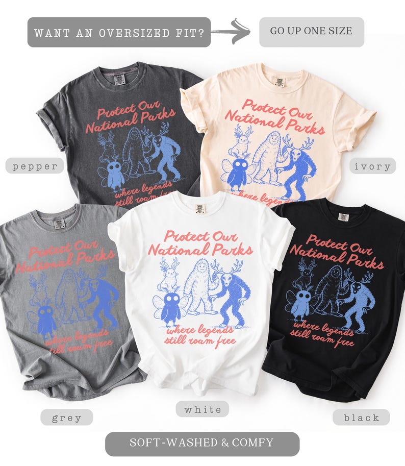 May include: A collection of soft-washed t-shirts in various colors, including pepper, ivory, grey, white, and black. Each shirt features the text "Protect Our National Parks" and a graphic of whimsical creatures. The shirts are labeled as "soft-washed & comfy."