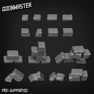 May include: A selection of grey, stone-like building blocks, arranged in different ways against a dark backdrop. The blocks are rectangular with a textured surface. The text "GOONMASTER" and "PRE-SUPPORTED" are visible.
