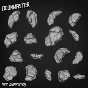 May include: A selection of grey, pre-supported, rock-like 3D models, set against a dark backdrop. The models have varied sizes and shapes, with textured surfaces and irregular forms. The text "GOONMASTER" and "PRE-SUPPORTED" are visible.