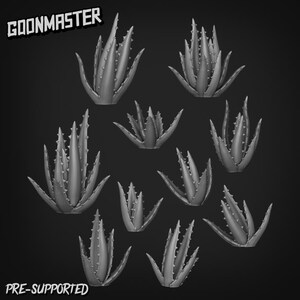 May include: A collection of grey aloe vera plants with spiky leaves, set against a dark background. The text "GOONMASTER" and "PRE-SUPPORTED" are visible in the image.