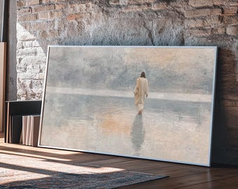 May include: A framed art print depicts a figure walking away on a reflective surface. The artwork features muted tones of beige, gray, and blue, with a textured appearance. The frame is white, and the artwork is leaning against a brick wall.