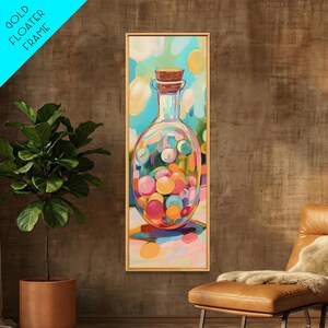 May include: A vertical rectangular wall art piece featuring a painting of a glass bottle filled with colorful round spheres, sealed with a cork stopper. The artwork is encased in a thin gold floater frame, displaying vibrant hues of blue, pink, and yellow.
