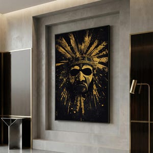 May include: A framed canvas art print featuring a stylized Native American face with a headdress. The artwork uses a black and gold color scheme, with the face and headdress in gold against a black background. The image has a modern, abstract style.