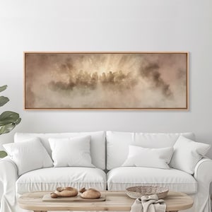 May include: A framed artwork depicts a group of silhouetted figures in a hazy, ethereal setting. The artwork features a warm color palette with shades of brown and gold, creating a sense of depth and mystery. The rectangular frame is made of light-colored wood.