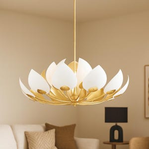 May include: A gold-colored, lotus-shaped chandelier with white, teardrop-shaped glass shades. The fixture is suspended from the ceiling and has a modern design. The chandelier is a decorative lighting element.