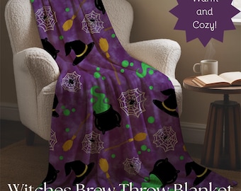 May include: A purple throw blanket with a Halloween theme, draped over a white armchair. The blanket features black witch hats, spiderwebs, brooms, and cauldrons with green potion designs. The text "Witches Brew Throw Blanket" is at the bottom.