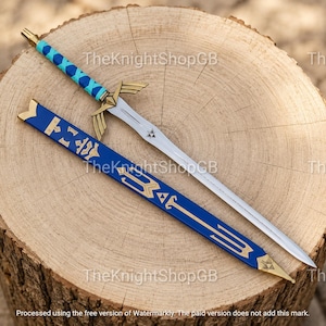 May include: A metal sword with a silver blade, a gold-coloured crossguard shaped like wings, and a handle wrapped in bright blue material. Beside it lies a blue scabbard featuring gold-coloured geometric patterns and a gold-coloured metal tip.