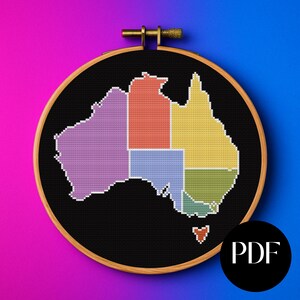 May include: A cross-stitch embroidery of the Australian continent, divided into colorful states and territories. The design is set in a black fabric within a wooden embroidery hoop. The word "PDF" is in a black circle in the lower right corner.