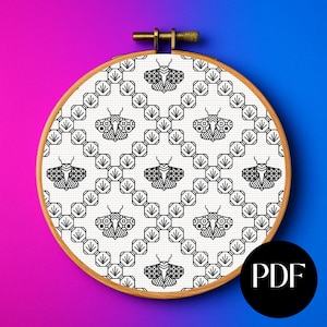 May include: A cross-stitch design showing a repeating pattern of black moths on white fabric, held in a wooden embroidery hoop. The design is geometric, with a diamond and octagon grid. A PDF icon is in the lower right corner.