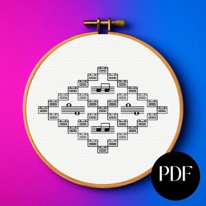 May include: A cross-stitch pattern of musical notes arranged in a diamond shape, displayed in a wooden embroidery hoop. The design features black musical symbols on a white fabric background. A PDF icon is visible in the lower right corner.