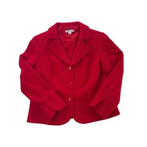 May include: A bright red blazer with a notched collar and three matching buttons. The jacket features a tailored fit with ribbed detailing on the cuffs and waist. The brand name "Pendleton" is visible on the label.