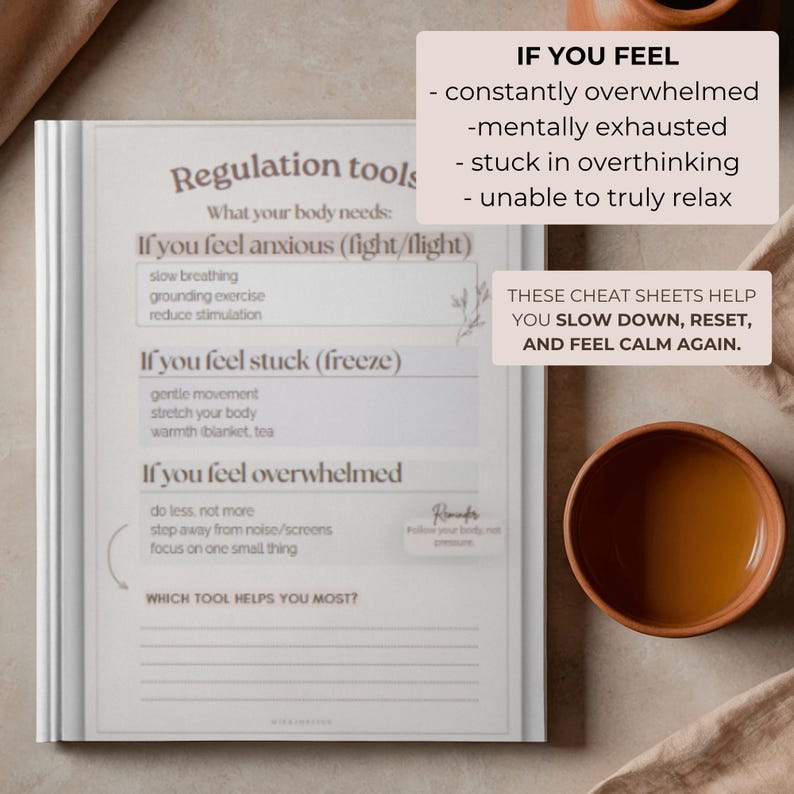 May include: A white notebook with the title "Regulation Tools" and text describing how to manage anxiety, feeling stuck, and feeling overwhelmed. The text includes "slow breathing" and "grounding exercise." A cup of tea sits nearby.