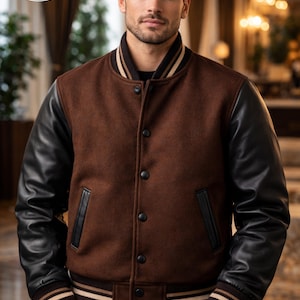 May include: Brown wool varsity jacket with black leather sleeves. The jacket features a button-up front, black leather pocket trim, and striped cuffs and waistband. The jacket has the text "PLANIO LEATHER" and "WHERE YOU GET QUALITY GOODS" in a circular logo.