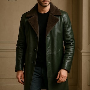 May include: A dark green leather coat with a brown shearling collar. The coat has a button-up front and a classic, tailored design. The coat is from Planio Leather.
