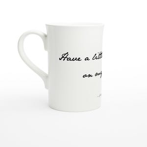 Op de afbeelding: Witte keramische mok met een gebogen handvat. De mok heeft zwarte cursieve tekst met de tekst "Have a little... on my..." De mok staat tegen een witte achtergrond.