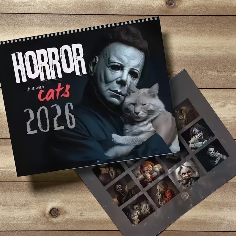 May include: A spiral-bound calendar with the words "HORROR" and "...but with cats 2026" in white and red text. The cover features a horror movie character holding a cat. The calendar is open to show images of horror characters.