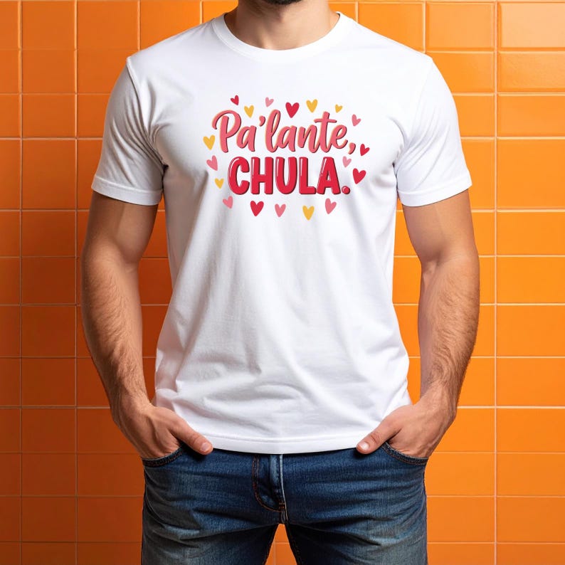 May include: White t-shirt with the text "Pa'lante, CHULA" in red and pink, surrounded by small heart graphics in red, pink, and yellow. The shirt is a crew neck style and is being worn.