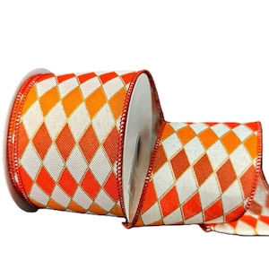 May include: A roll of wired ribbon featuring a repeating diamond pattern in vibrant orange and off-white. The edges of the ribbon are finished with a thin, metallic gold thread, providing a structured look for the fabric material on the spool.