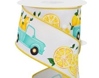 May include: White ribbon with a teal blue pickup truck carrying lemons and yellow lemons on a white background with a gold trim.