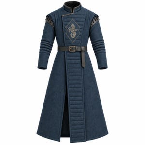 May include: A long, dark blue quilted coat featuring a high collar, long sleeves with ribbed detailing, and a black belt at the waist. The chest displays a diamond-shaped patch with an embroidered silver seahorse emblem, and the coat has a front opening.