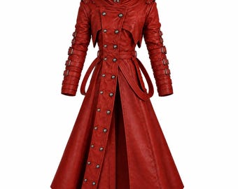 May include: A long, vibrant red coat featuring a high collar, double-breasted front with metallic buttons, and long sleeves adorned with multiple horizontal buckled straps. The garment includes a waist belt and a flared, floor-length skirt.