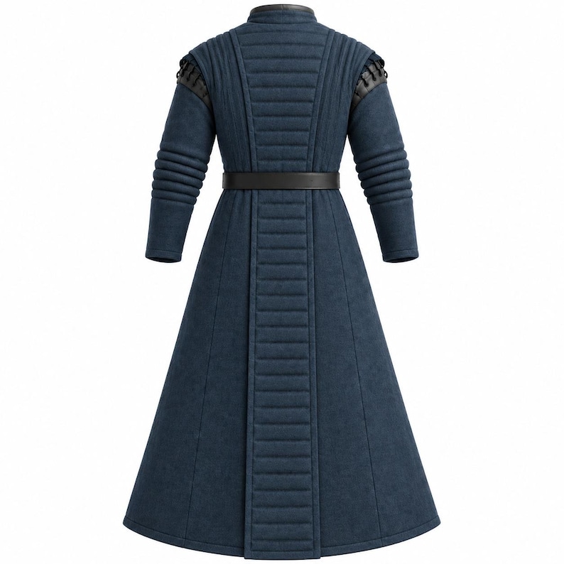 May include: A long, dark blue coat featuring a high collar, quilted vertical paneling on the back and sleeves, and a black belt at the waist. The shoulders are accented with black leather-like detailing and lacing, creating a structured appearance.