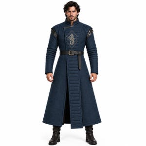 May include: A long, dark blue quilted coat featuring a high collar, structured shoulders, and a central vertical panel. A black belt with a silver buckle cinches the waist. An embroidered diamond-shaped emblem with a seahorse motif is on the chest.