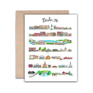 May include: A watercolor illustration of Dexter, MI, featuring a variety of buildings and landmarks. The artwork is on a white card with a brown envelope. The text "Dexter, mi" is written in cursive at the top of the card.