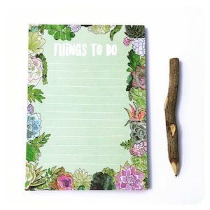 May include: A green notepad with a border of colorful succulent illustrations. The notepad has lined pages and the words "Things to do" printed at the top.