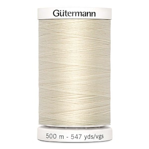 May include: A spool of off-white Gütermann thread. The spool is cylindrical with a white top and bottom, and the thread is tightly wound around the core. The bottom of the spool has the text "500 m - 547 yds/vgs".