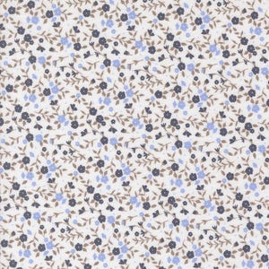 May include: A fabric with a repeating floral pattern. Small, dark blue and light blue flowers are scattered across a white background. Brown stems and leaves connect the flowers, creating a delicate, all-over design.