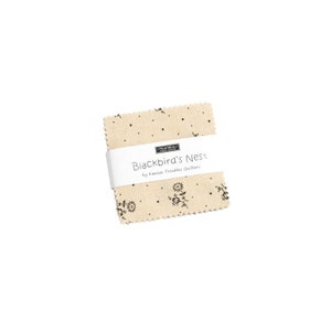 May include: A beige fabric square with a blackbird's nest design and black polka dots. The fabric is labeled "Blackbird's Nest" by Kansas Troubles Quilters.