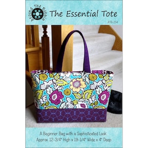 May include: The Essential Tote bag with a floral pattern in turquoise, purple, and yellow. The bag has purple handles and a purple geometric patterned base. The text on the bag reads "The Essential Tote" and "A Beginner Bag with a Sophisticated Look". The bag is approximately 12-3/4" high, 19-1/4" wide, and 4" deep.