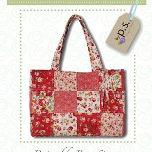 May include: A red, white, and pink floral patchwork tote bag with a brown tag that says "by p.s. Penny Sturges". The bag is designed by Penny Sturges and is called "ps028 Garden Party".