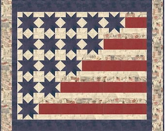 May include: A patriotic quilt featuring the American flag design. The quilt showcases a navy blue border and a central field of blue star shapes and red stripes. The background has a vintage newspaper print.