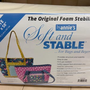 May include: White foam stabilizer by Annie's, 36" x 58" (91.5 cm x 147 cm), for bags and beyond. The packaging features two fabric bag designs. Text on the packaging includes "Soft and Stable" and product details.